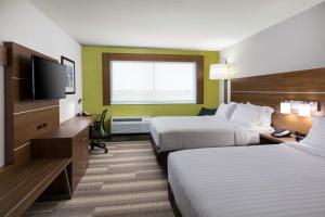 a hotel room with two beds and a television at Holiday Inn Express Visalia-Sequoia Gateway Area, an IHG Hotel in Visalia