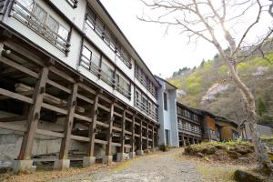 a large white building with windows on the side of it at Namegawaonsen Fukushimaya in Yonezawa