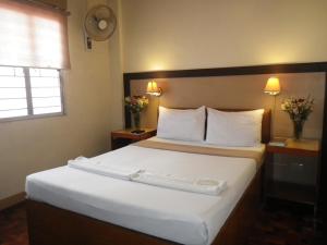 Postel nebo postele na pokoji v ubytování Baguio Holiday Villas