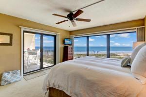 阿米莉亚岛Amelia Island Oceanfront 2 Master Suites的一间带床的卧室和一个可欣赏海景的阳台