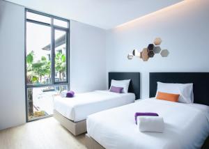 Säng eller sängar i ett rum på Chaweng Villawee Hotel - SHA Plus