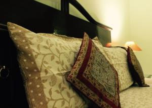 a couple of pillows sitting on a bed at Udai Niwas - a boutique homestay in Bikaner