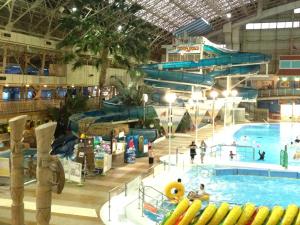 a large indoor swimming pool with a water slide at Hotel Crown Hills Iwaki in Iwaki