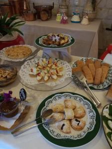 a table with plates of pastries and other foods at Masseria Asciano in Ostuni