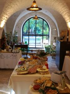 a table filled with plates of food in a room at Masseria Asciano in Ostuni