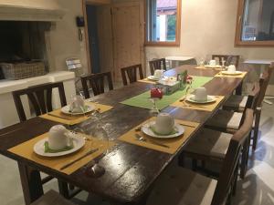 a large wooden table with plates and napkins on it at Agriturismo Corte Bertesina in Vicenza