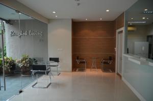 a lobby with chairs and a table in a building at Bangkok Living in Bangkok +13 photos