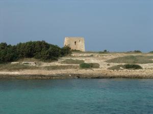 an old building on an island in the water at Masseria Asciano in Ostuni