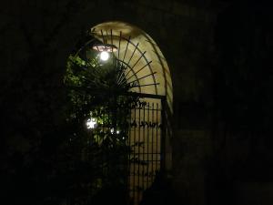a building with a gate at night with lights at Masseria Asciano in Ostuni
