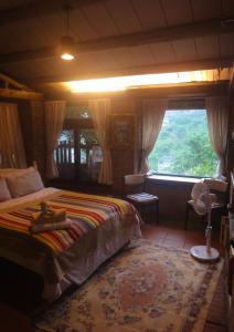 a bedroom with a bed and a large window at Jiufen Aromatherapy B&B in Jiufen