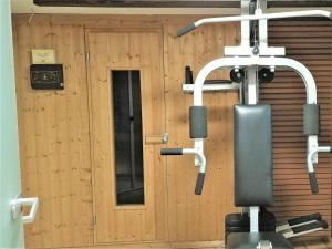 a gym with a wooden wall with a door at Apartment Gabriele in Sinsheim