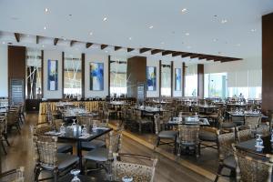 a dining room filled with tables and chairs at Arterra Hotel and Resort in Mactan