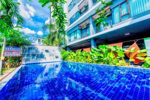 a swimming pool in front of a building at Tree Boutique Resort in Chiang Mai