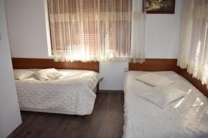 a bedroom with two beds and a window at Complex Oazis in Etropole