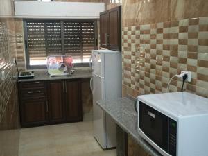 A kitchen or kitchenette at Al haramain Furnished Apartments