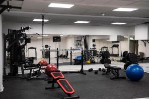 a gym with a lot of equipment and weights at Clarion Collection Hotel Smedjan in Sandviken