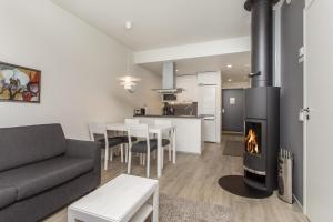 a living room with a couch and a fireplace at Holiday Club Himos Superior Apartments in Jämsä