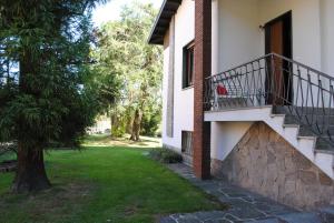 ein Gebäude mit einer Treppe neben einem Baum in der Unterkunft Bnbook Garden View Villa in Sesto Calende
