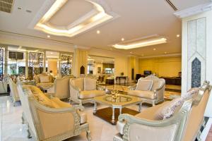 a lobby with chairs and tables and a salon at LK Royal Suite in Pattaya
