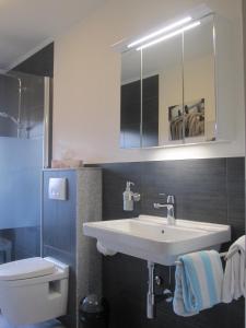 a bathroom with a sink and a toilet at Ferienwohnung Andrea in Eberbach