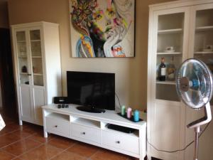 a living room with a white tv and a fan at Aguamarina - Golf del Sur - San Miguel de Abona - VV - Holiday Home in San Miguel de Abona