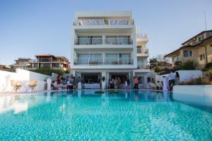 a large swimming pool in front of a building at Sea Sense Boutique Hotel & Wellness in Sozopol