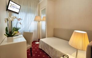 Postel nebo postele na pokoji v ubytování Hotel Gamma