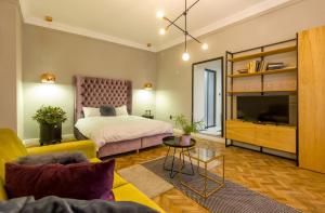 una camera con letto, TV e divano di Köte Haus a Cluj-Napoca
