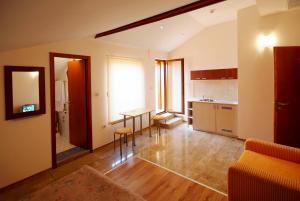 a living room with a table and a kitchen at Family Hotel Saint Nikola in Nesebar
