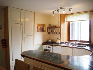 a kitchen with a sink and a counter top at Corbie Self Catering Shetland in Lerwick