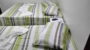 Un pat sau paturi într-o cameră la Pousada Pai Nosso