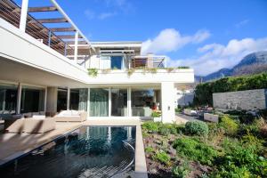 a villa with a swimming pool and a house at Thirty On Grace in Cape Town