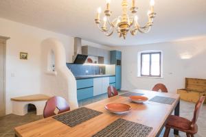 una cucina e una sala da pranzo con tavolo e sedie in legno di Jagerhof a Caldaro