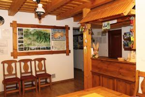 a room with two chairs and a counter in a building at Penzión Luka in Terchová