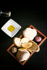 a plate of food with bread and dipping sauce at Pousada de Lisboa - Small Luxury Hotels Of The World in Lisbon