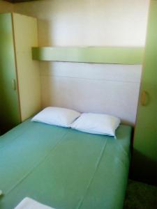 A bed or beds in a room at Parque de Campismo Orbitur Sao Jacinto