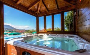 a jacuzzi tub in a house with a pool at Hotel Ristorante Borgo La Tana in Maratea