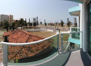 a view from a balcony of a building with a roof at Praia Sul Studios in Peruíbe