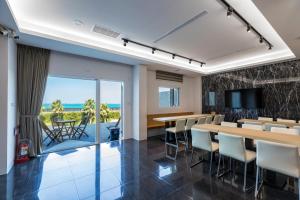 a conference room with tables and chairs and a television at Jia Xiang Lin Guan Hai Homestay 2 in Magong