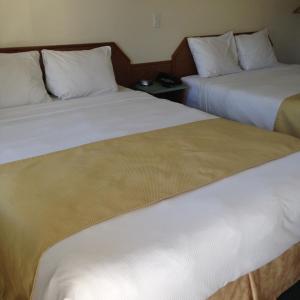 Voodi või voodid majutusasutuse The Ranchland Inn Kamloops toas