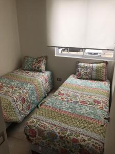 Cama o camas de una habitación en Departamento Serena Pacífico