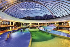 a large building with a swimming pool and a glass dome at Apartment Janja in Vojnik