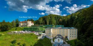 a group of buildings on a hill with trees at Apartment Janja in Vojnik