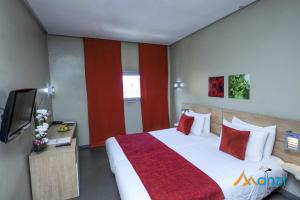 A bed or beds in a room at Manzil Hotel