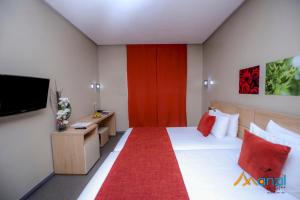 A bed or beds in a room at Manzil Hotel