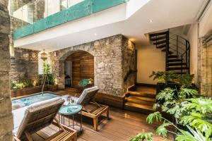 an indoor courtyard with a jacuzzi tub and stairs at Edelmira Hotel Boutique in Guanajuato