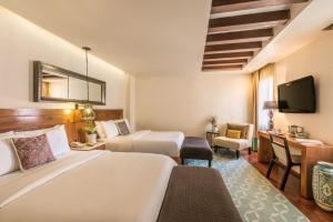 Postel nebo postele na pokoji v ubytování Edelmira Hotel Boutique