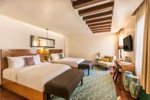 Postel nebo postele na pokoji v ubytování Edelmira Hotel Boutique