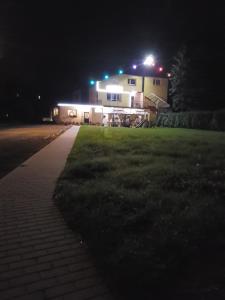 a house with lights on top of it at night at Euro Zajazd - Casa Di Fulvio Maria Viola in Bielsko-Biała