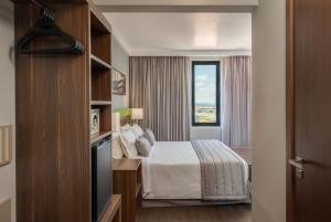 Cama ou camas em um quarto em Linx Confins